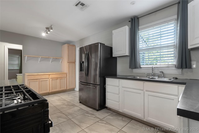 1228 S Erie Ave, Tulsa, OK 74112 - kitchen featuring a sink, stainless steel refrigerator with ice dispenser, light marble finish floors, open shelves, and dark countertops