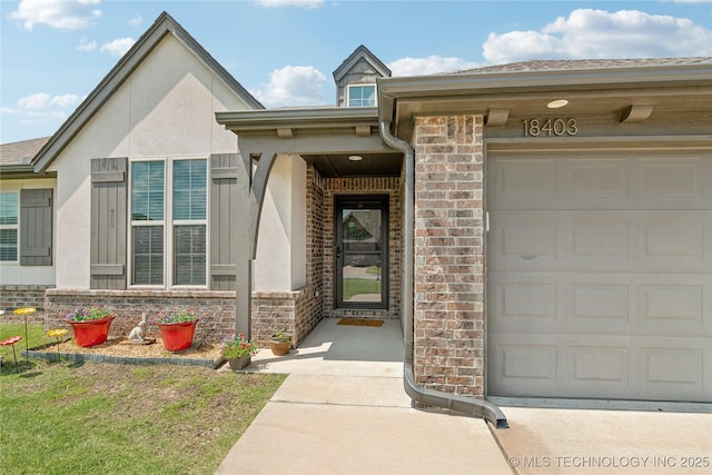 18403 E 50th St, Tulsa, OK 74134 - view of exterior entry featuring a garage, stucco siding, and brick siding