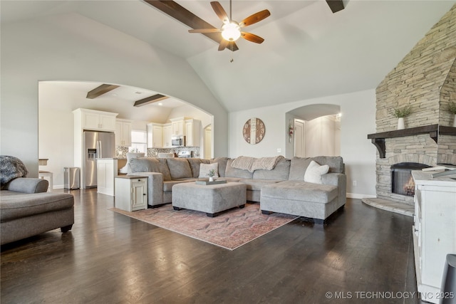 18403 E 50th St, Tulsa, OK 74134 - living area with ceiling fan, arched walkways, a fireplace, dark wood-style floors, and high vaulted ceiling