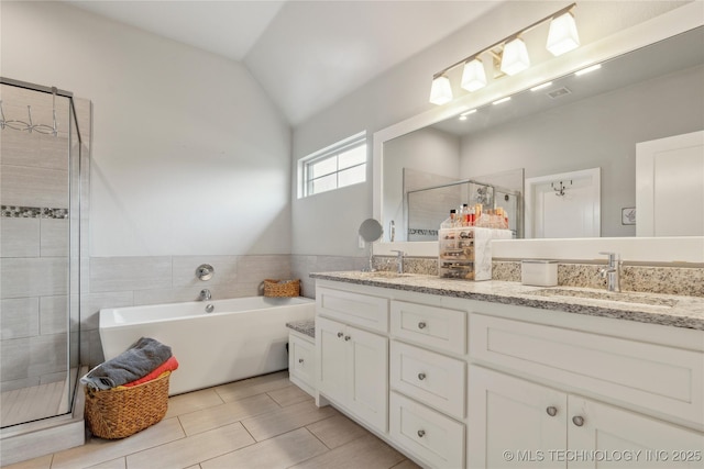 18403 E 50th St, Tulsa, OK 74134 - bathroom with double vanity, a bathtub, a stall shower, and lofted ceiling