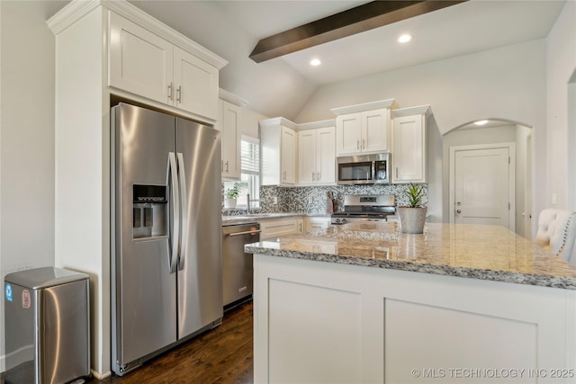 18403 E 50th St, Tulsa, OK 74134 - kitchen featuring appliances with stainless steel finishes, dark wood-style floors, backsplash, white cabinets, and lofted ceiling