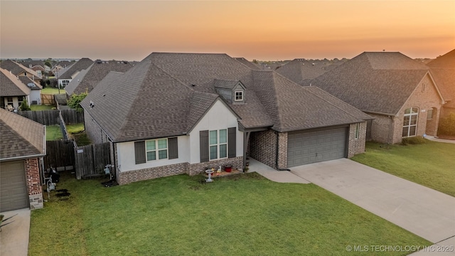 18403 E 50th St, Tulsa, OK 74134 - view of front of house with a garage, brick siding, a shingled roof, driveway, and stucco siding