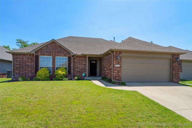 4815 S 189th E Ave, Tulsa, OK 74134 - view of front of house featuring brick siding, a garage, a front yard, concrete driveway, and central AC