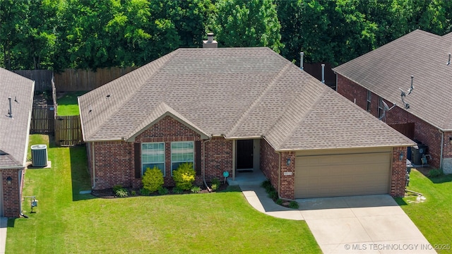 4815 S 189th E Ave, Tulsa, OK 74134 - view of front facade with brick siding, a garage, concrete driveway, and roof with shingles