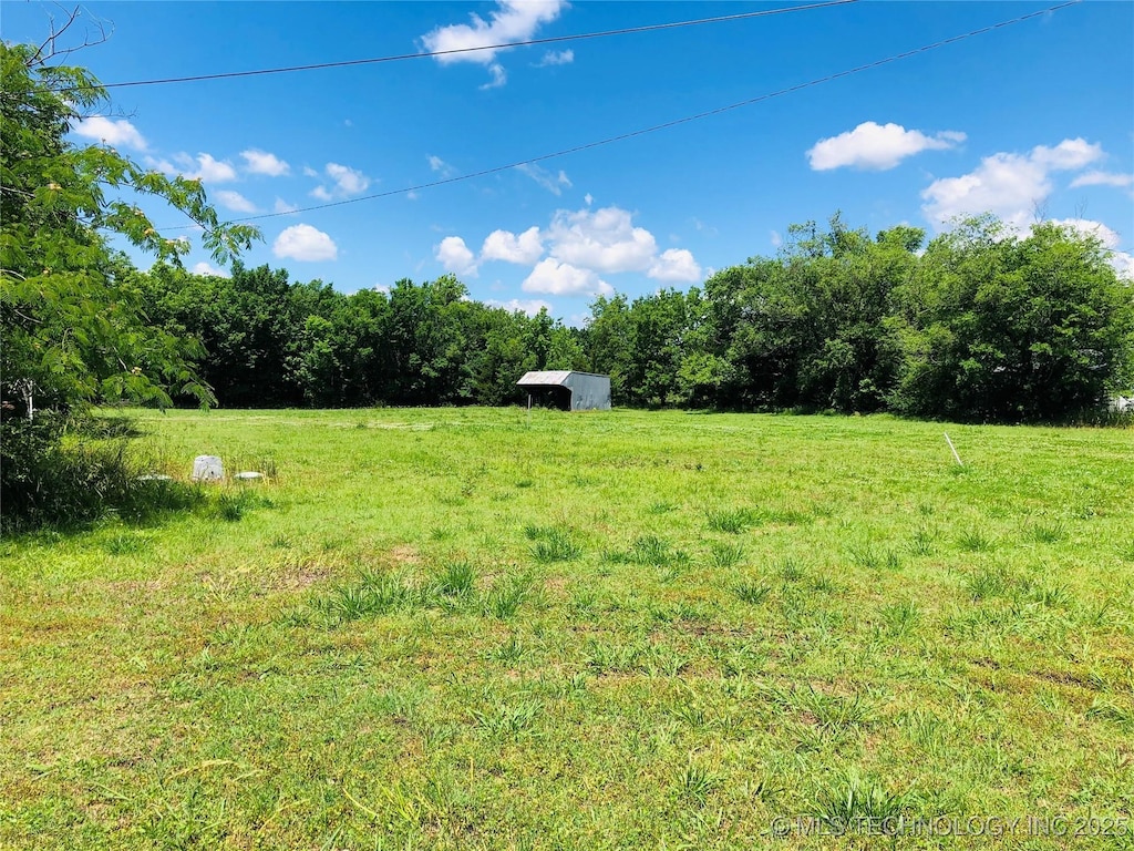 1145 S Little Ave, Cushing, OK 74023 - view of yard with a view of countryside, an outdoor structure, and a wooded view