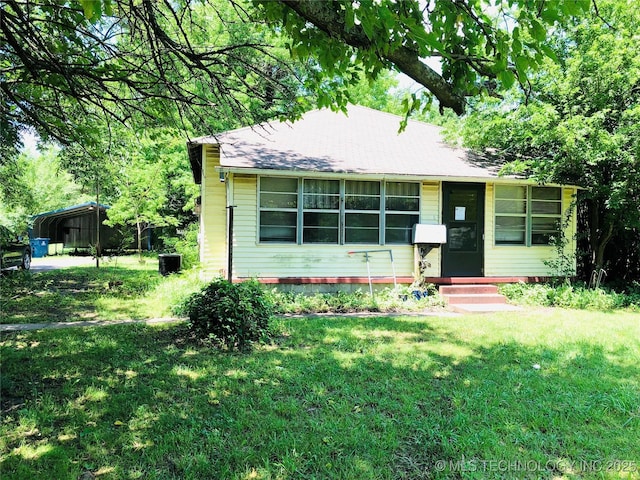 1145 S Little Ave, Cushing, OK 74023 - view of front of property with a front lawn, entry steps, and a shingled roof