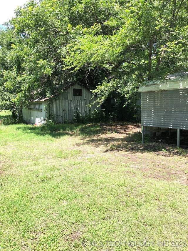 1145 S Little Ave, Cushing, OK 74023 - view of green lawn with an outdoor structure and an outbuilding