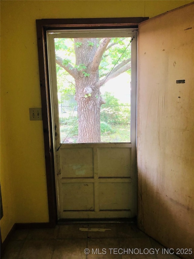 1145 S Little Ave, Cushing, OK 74023 - doorway to outside with plenty of natural light and dark tile patterned floors