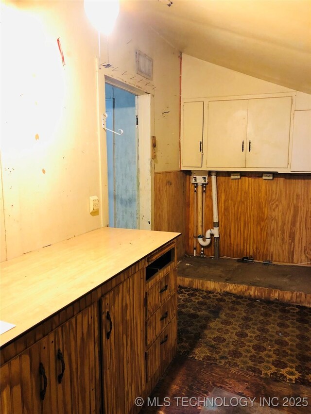 1145 S Little Ave, Cushing, OK 74023 - kitchen with lofted ceiling, white cabinetry, and light countertops
