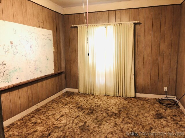 1145 S Little Ave, Cushing, OK 74023 - carpeted spare room with wooden walls and ornamental molding