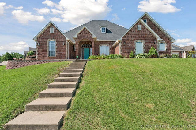 316 E 44th St, Sand Springs, OK 74063 - view of front of home with brick siding, a front yard, and roof with shingles