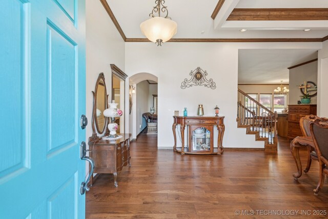 316 E 44th St, Sand Springs, OK 74063 - foyer entrance with arched walkways, crown molding, a chandelier, wood finished floors, and stairway