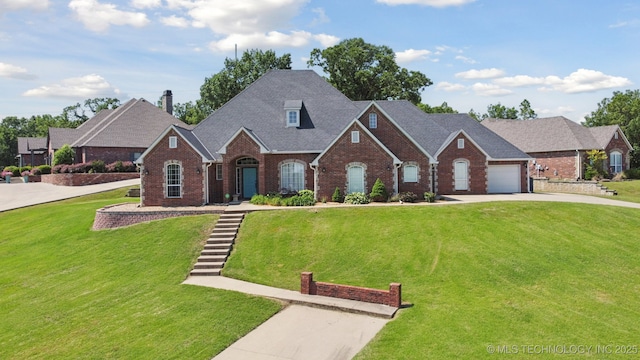 316 E 44th St, Sand Springs, OK 74063 - view of front of property featuring brick siding, concrete driveway, a front yard, and an attached garage