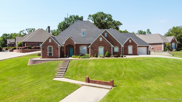 316 E 44th St, Sand Springs, OK 74063 - view of front of home with brick siding, concrete driveway, a front lawn, and a garage