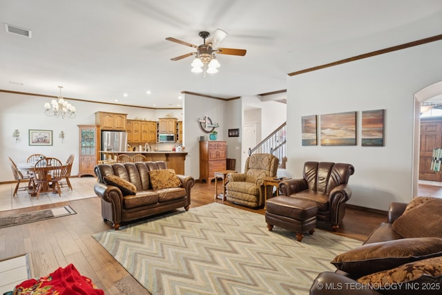 316 E 44th St, Sand Springs, OK 74063 - living area with ornamental molding, ceiling fan, stairs, a chandelier, and light wood-style floors