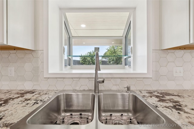 2817 W Oakland St, Broken Arrow, OK 74012 - kitchen view of backsplash, a sink, and white cabinets