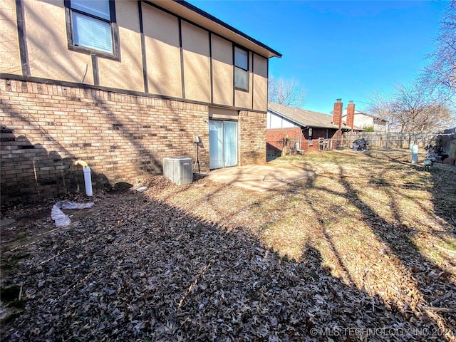 7205 S Date Pl, Broken Arrow, OK 74011 - back of house featuring brick siding, central air condition unit, and a patio area