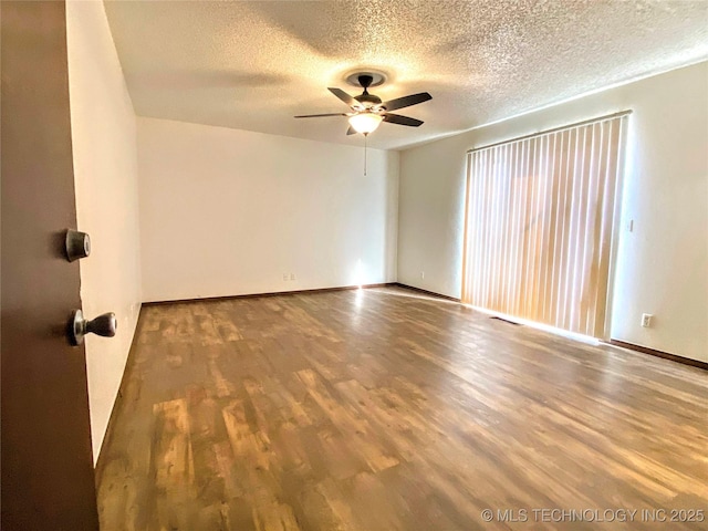 7205 S Date Pl, Broken Arrow, OK 74011 - empty room with a ceiling fan, wood finished floors, a textured ceiling, and baseboards