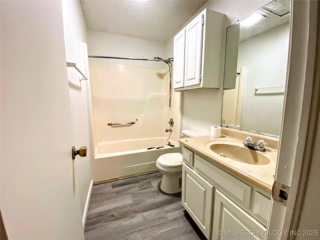 7205 S Date Pl, Broken Arrow, OK 74011 - bathroom with toilet, vanity, wood finished floors, shower / tub combination, and a textured ceiling
