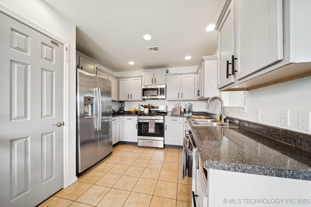 510 S Creek St, Skiatook, OK 74070 - kitchen with stainless steel appliances, light tile patterned floors, a sink, and recessed lighting