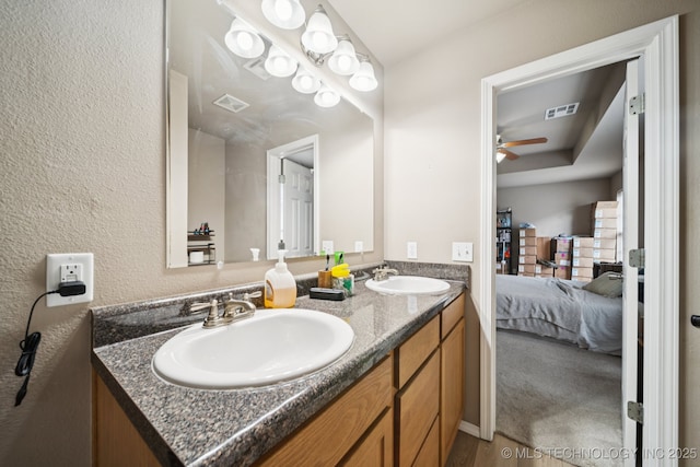 510 S Creek St, Skiatook, OK 74070 - ensuite bathroom with double vanity, a ceiling fan, and a textured wall