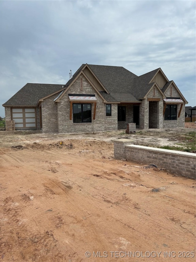 4247 E 179th St S, Bixby, OK 74008 - view of front of home featuring brick siding, roof with shingles, and a garage