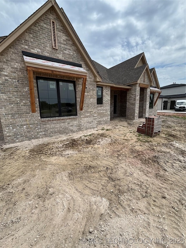 4247 E 179th St S, Bixby, OK 74008 - rear view of house with brick siding and roof with shingles