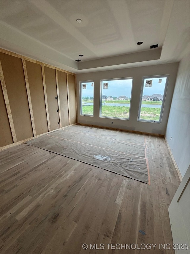 4247 E 179th St S, Bixby, OK 74008 - unfurnished bedroom with wood finished floors and a tray ceiling