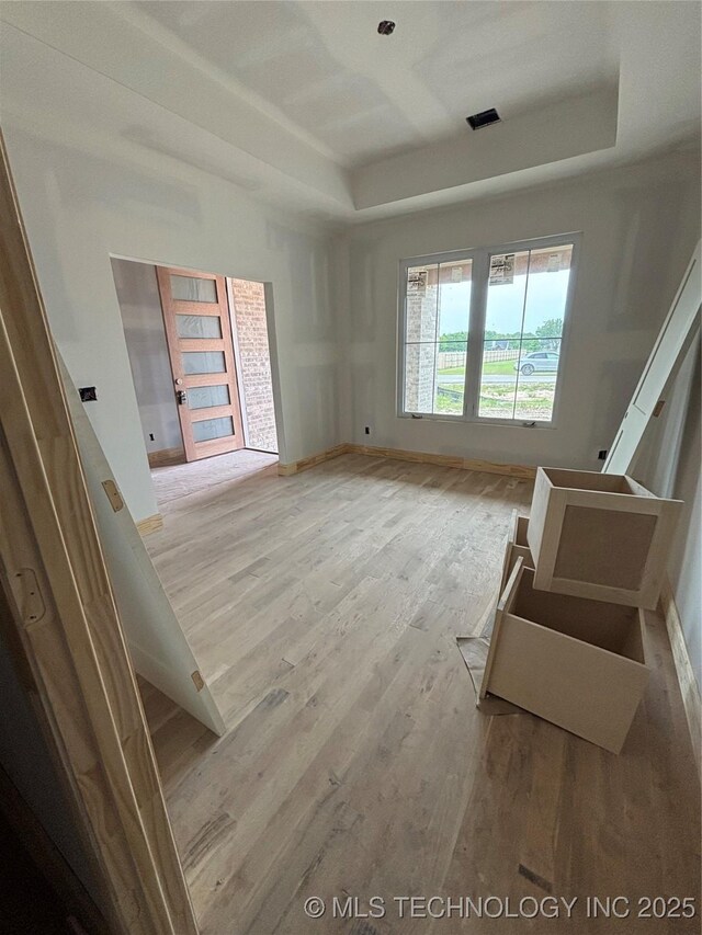 4247 E 179th St S, Bixby, OK 74008 - unfurnished room with a raised ceiling, wood finished floors, and baseboards