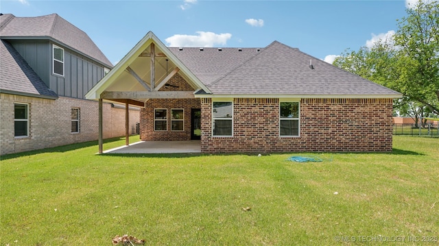 2508 W Birmingham St, Broken Arrow, OK 74011 - rear view of property with a shingled roof, a patio area, brick siding, and a lawn