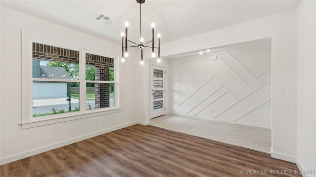 2508 W Birmingham St, Broken Arrow, OK 74011 - unfurnished dining area featuring wood finished floors and a chandelier