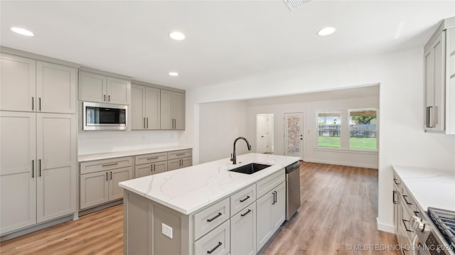 2508 W Birmingham St, Broken Arrow, OK 74011 - kitchen with a sink, appliances with stainless steel finishes, gray cabinetry, light wood-style floors, and recessed lighting