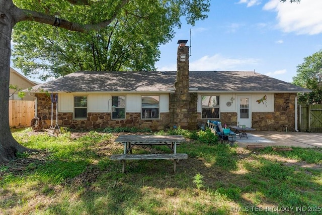 412 W Los Angeles St, Broken Arrow, OK 74011 - rear view of property with stone siding, a chimney, roof with shingles, and a patio area