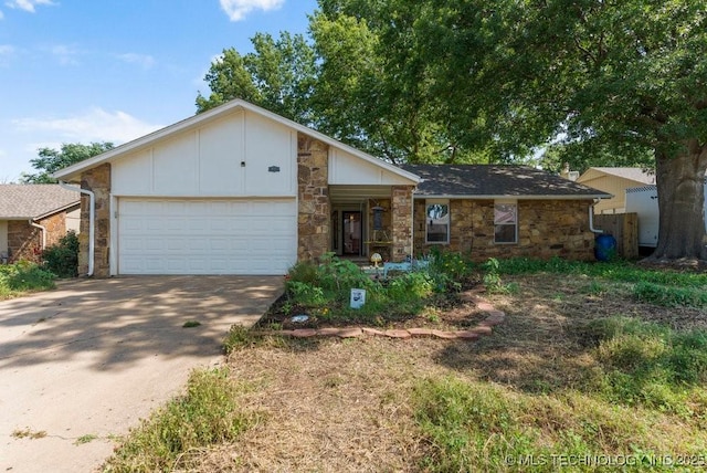 412 W Los Angeles St, Broken Arrow, OK 74011 - view of front of house featuring stone siding, an attached garage, concrete driveway, and board and batten siding