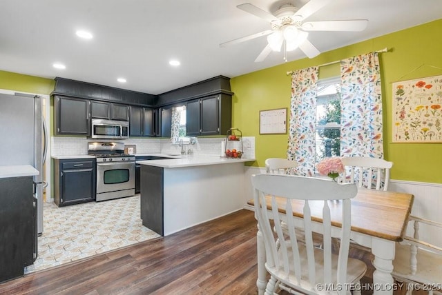 412 W Los Angeles St, Broken Arrow, OK 74011 - kitchen featuring appliances with stainless steel finishes, a peninsula, healthy amount of natural light, backsplash, and recessed lighting