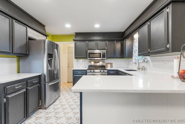 412 W Los Angeles St, Broken Arrow, OK 74011 - kitchen with stainless steel appliances, a sink, light countertops, and recessed lighting