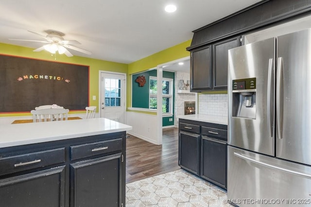 412 W Los Angeles St, Broken Arrow, OK 74011 - kitchen featuring stainless steel fridge with ice dispenser, light countertops, ceiling fan, decorative backsplash, and recessed lighting