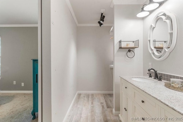 412 W Los Angeles St, Broken Arrow, OK 74011 - bathroom featuring vanity, wood finished floors, ornamental molding, and baseboards