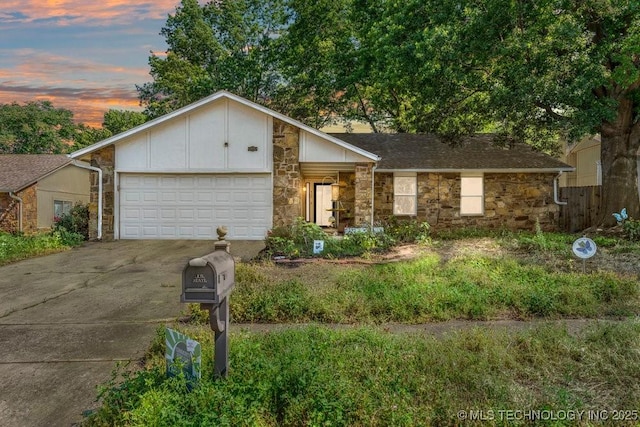 412 W Los Angeles St, Broken Arrow, OK 74011 - mid-century modern home featuring stone siding, an attached garage, driveway, and board and batten siding