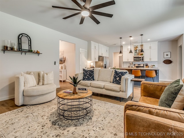 7221 S Indianwood Ave, Broken Arrow, OK 74011 - living room featuring light wood-style flooring, ceiling fan, baseboards, and recessed lighting