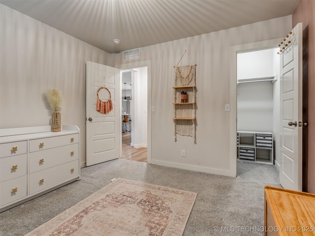 7221 S Indianwood Ave, Broken Arrow, OK 74011 - carpeted bedroom featuring a walk in closet and baseboards