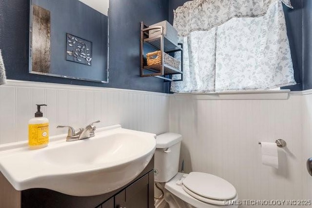 1138 N Gum Ave, Broken Arrow, OK 74012 - bathroom featuring a wainscoted wall, toilet, and vanity