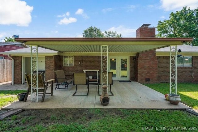 1138 N Gum Ave, Broken Arrow, OK 74012 - rear view of house with brick siding, a chimney, a patio area, and french doors
