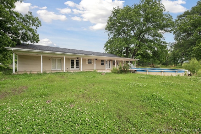 385077 E 1160th Rd, Weleetka, OK 74880 - back of property with french doors, an outdoor pool, and a yard