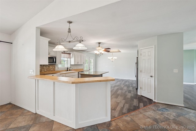 385077 E 1160th Rd, Weleetka, OK 74880 - kitchen featuring appliances with stainless steel finishes, a sink, white cabinets, light countertops, and backsplash