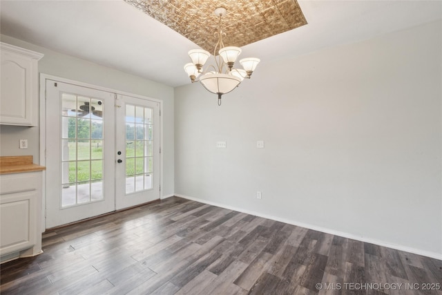 385077 E 1160th Rd, Weleetka, OK 74880 - unfurnished dining area featuring dark wood-style floors, a chandelier, an ornate ceiling, french doors, and baseboards