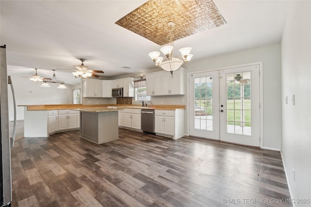 385077 E 1160th Rd, Weleetka, OK 74880 - kitchen featuring appliances with stainless steel finishes, white cabinets, dark wood finished floors, a chandelier, and ceiling fan