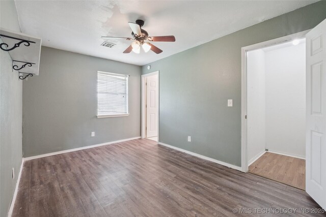 385077 E 1160th Rd, Weleetka, OK 74880 - unfurnished room featuring wood finished floors, a ceiling fan, and baseboards