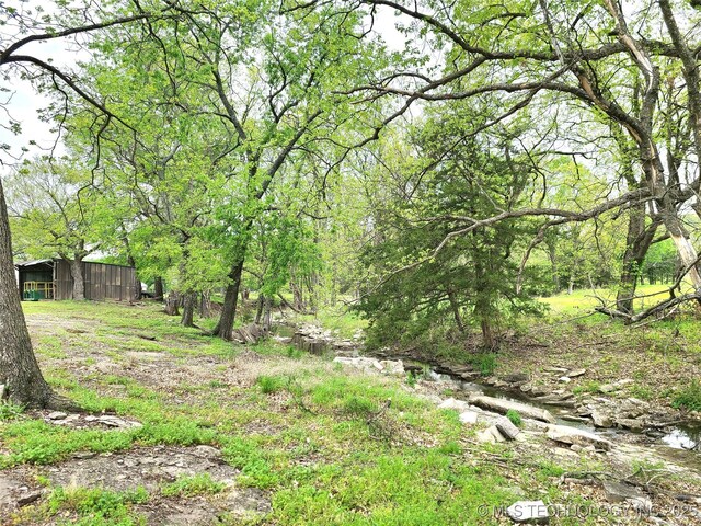 1950 Cedar Bluff Rd, Fort Gibson, OK 74434 - view of yard with a pole building, an outbuilding, and a view of trees