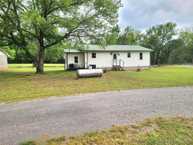 1950 Cedar Bluff Rd, Fort Gibson, OK 74434 - back of property featuring entry steps, a lawn, and metal roof